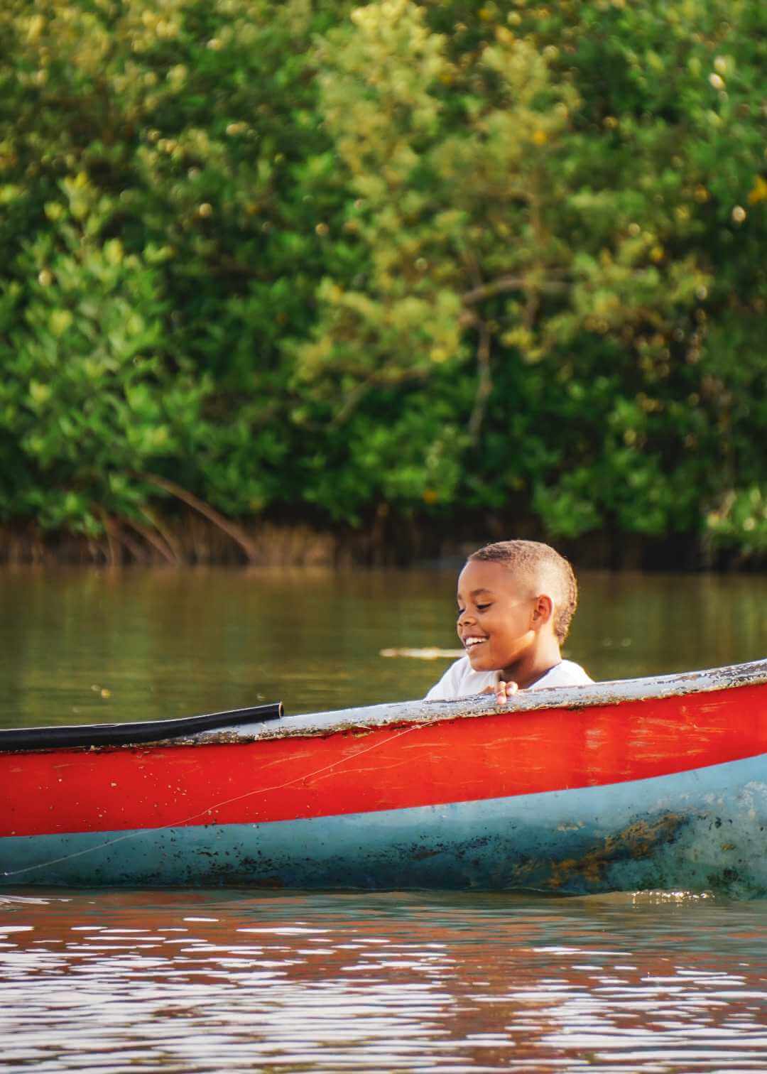 Niño en canoa sobre la ciénaga